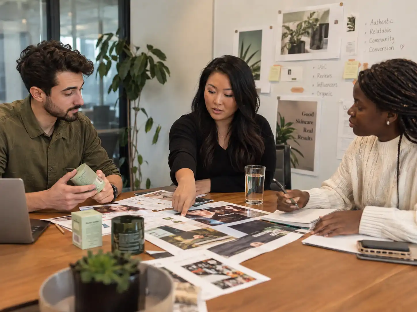 Marketing team reviewing product feedback and influencer content materials during a brand strategy meeting