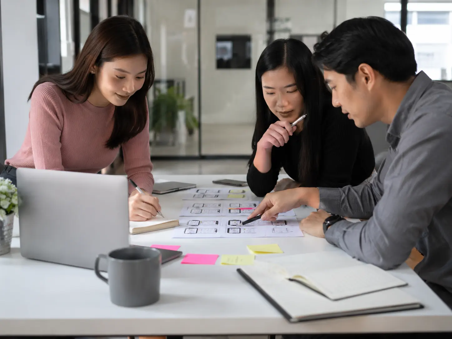 Product team collaborating on documentation and knowledge resources in a modern office